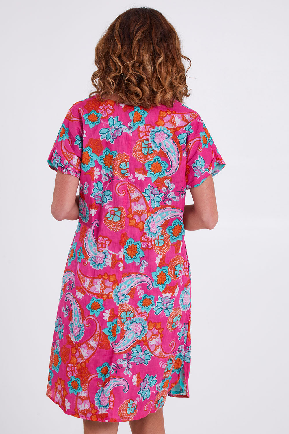 Model Emma wearing size 10 of the Symi Reversible Shift Organic Cotton Dress in colour Aquapink (Pink), from the back