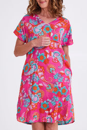 Model Emma wearing size 10 of the Symi Reversible Shift Organic Cotton Dress in colour Aquapink (Pink), from the front, cropped image