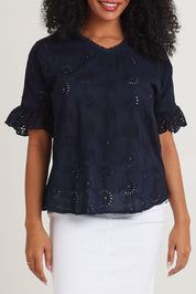 Model Ziara wearing size 10 of the Essentials Broderie Cotton Top in colour Navy (Blue), from the front, cropped image