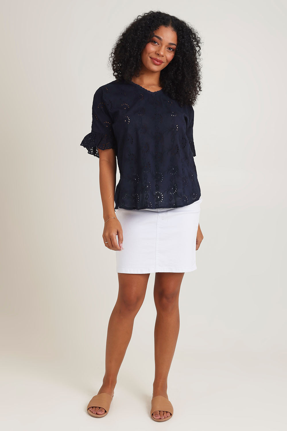 Model Ziara wearing size 10 of the Essentials Broderie Cotton Top in colour Navy (Blue), from the front, showing the whole outfit