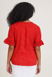 Model Ziara wearing size 10 of the Essentials Broderie Cotton Top in colour Red (Red), from the back