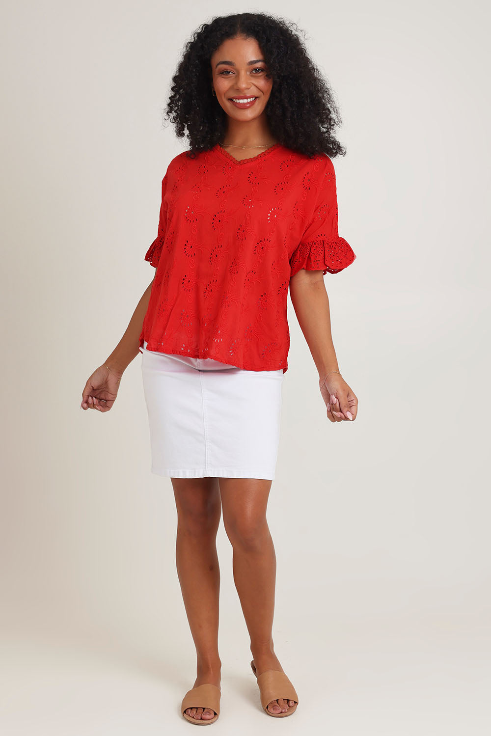 Model Ziara wearing size 10 of the Essentials Broderie Cotton Top in colour Red (Red), from the front, showing the whole outfit