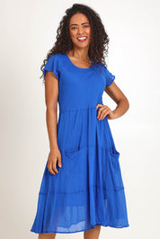 Model Pamelar wearing size 10 of the Essentials Bias Pockets Cotton Dress - Blue in colour Blue, in a cropped view