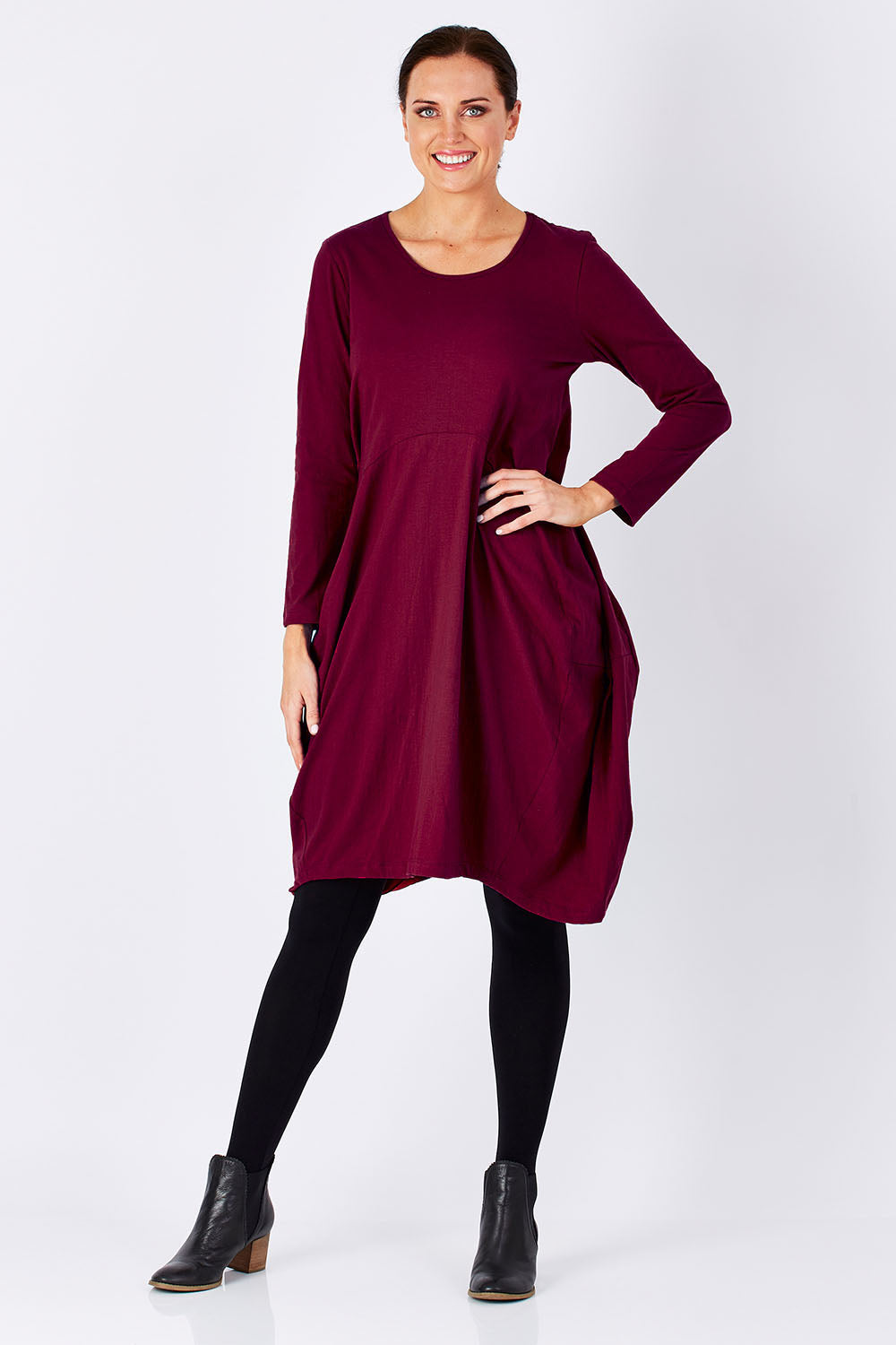 Model Perrie wearing size 10 of the Bubble Dress in colour BurntRed (Red), from the front, showing the whole outfit