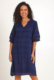 Model Pamelar wearing size 10 of the Essentials Pleated Cotton Dress - Navy in colour Navy, in a cropped view
