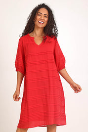 Model Pamelar wearing size 10 of the Essentials Pleated Cotton Dress - Red in colour Red, in a cropped view