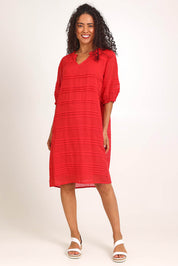 Model Pamelar wearing size 10 of the Essentials Pleated Cotton Dress - Red in colour Red, from the front