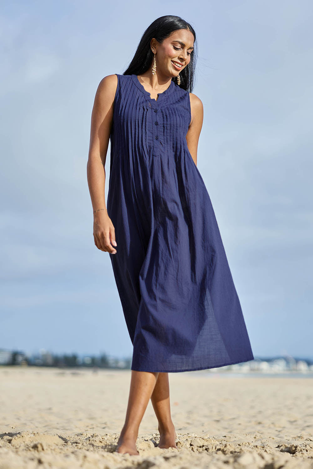 Model Eshan wearing size 10 of the Essentials Pleated Cotton Dress - Navy in colour Navy, from the front