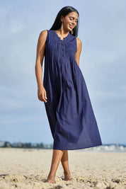 Model Eshan wearing size 10 of the Essentials Pleated Cotton Dress - Navy in colour Navy, from the front