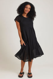 Model Ziara wearing size 10 of the Essentials Bias Pockets Cotton Dress in colour Black (Black), from the front, showing the whole outfit