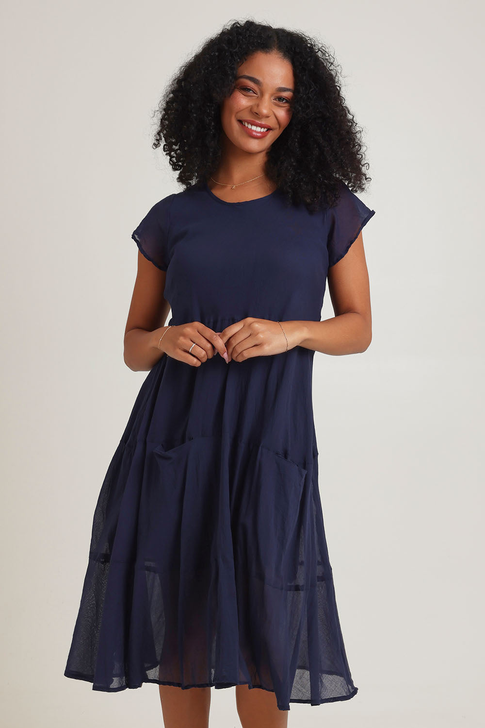 Model Ziara wearing size 10 of the Essentials Bias Pockets Cotton Dress in colour Navy (Blue), from the front, cropped image