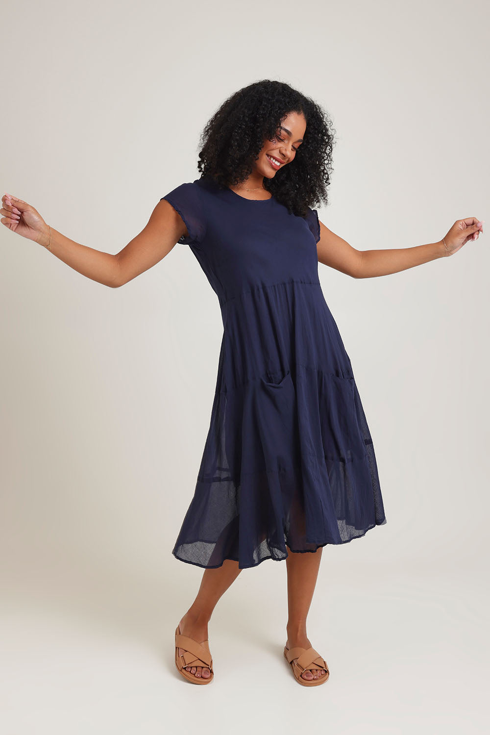 Model Ziara wearing size 10 of the Essentials Bias Pockets Cotton Dress in colour Navy (Blue), from the front, showing the whole outfit