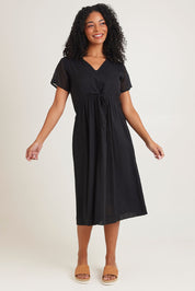 Model Ziara wearing size 10 of the Essentials Tie Waist Cotton Dress in colour Black (Black), from the front, showing the whole outfit
