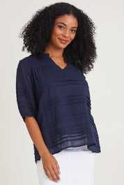 Model Ziara wearing size 10 of the Essentials Organic Cotton Pleated Top in colour Navy (Blue), from the front, cropped image