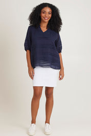 Model Ziara wearing size 10 of the Essentials Organic Cotton Pleated Top in colour Navy (Blue), from the front, showing the whole outfit