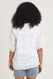 Model Ziara wearing size 10 of the Essentials Organic Cotton Pleated Top in colour White (White), from the back