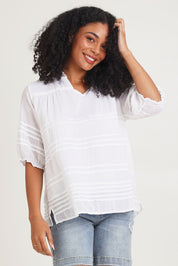 Model Ziara wearing size 10 of the Essentials Organic Cotton Pleated Top in colour White (White), from the front, cropped image