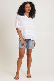 Model Ziara wearing size 10 of the Essentials Organic Cotton Pleated Top in colour White (White), from the front, showing the whole outfit