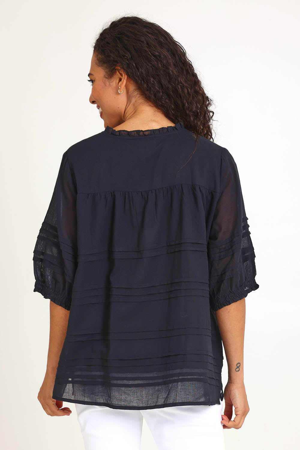 Model Pamelar wearing size 10 of the Essentials Pleated Cotton Top - Black in colour Black, from the back