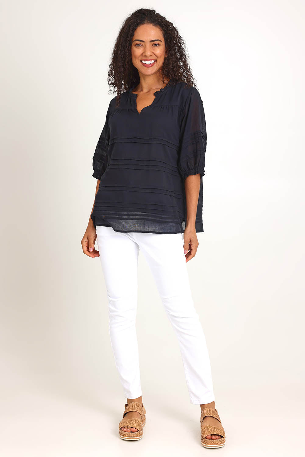 Model Pamelar wearing size 10 of the Essentials Pleated Cotton Top - Black in colour Black, from the front