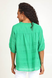 Model Pamelar wearing size 10 of the Essentials Pleated Cotton Top - Green in colour Green, from the back