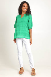 Model Pamelar wearing size 10 of the Essentials Pleated Cotton Top - Green in colour Green, from the front