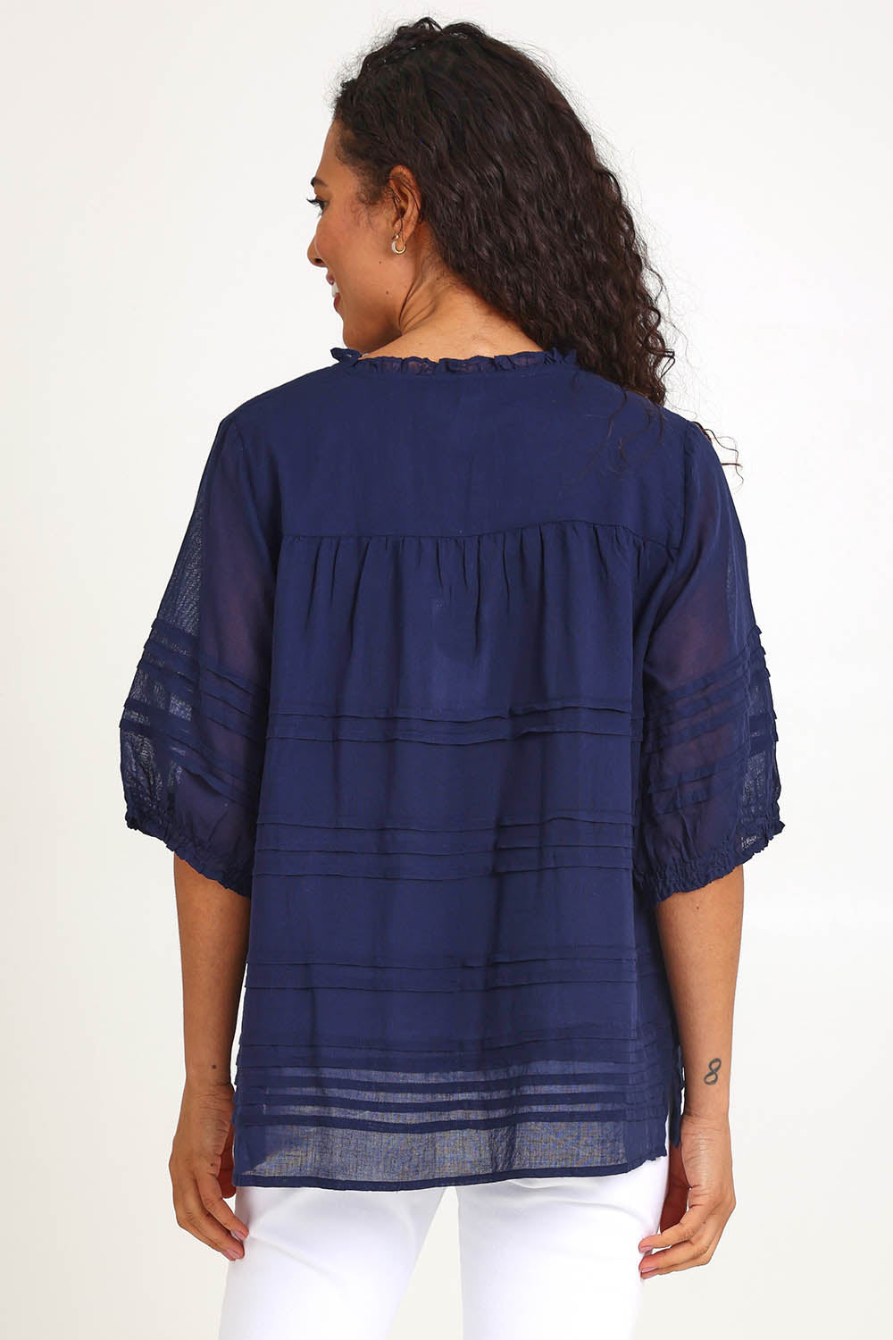 Model Pamelar wearing size 10 of the Essentials Pleated Cotton Top - Navy in colour Navy, from the back