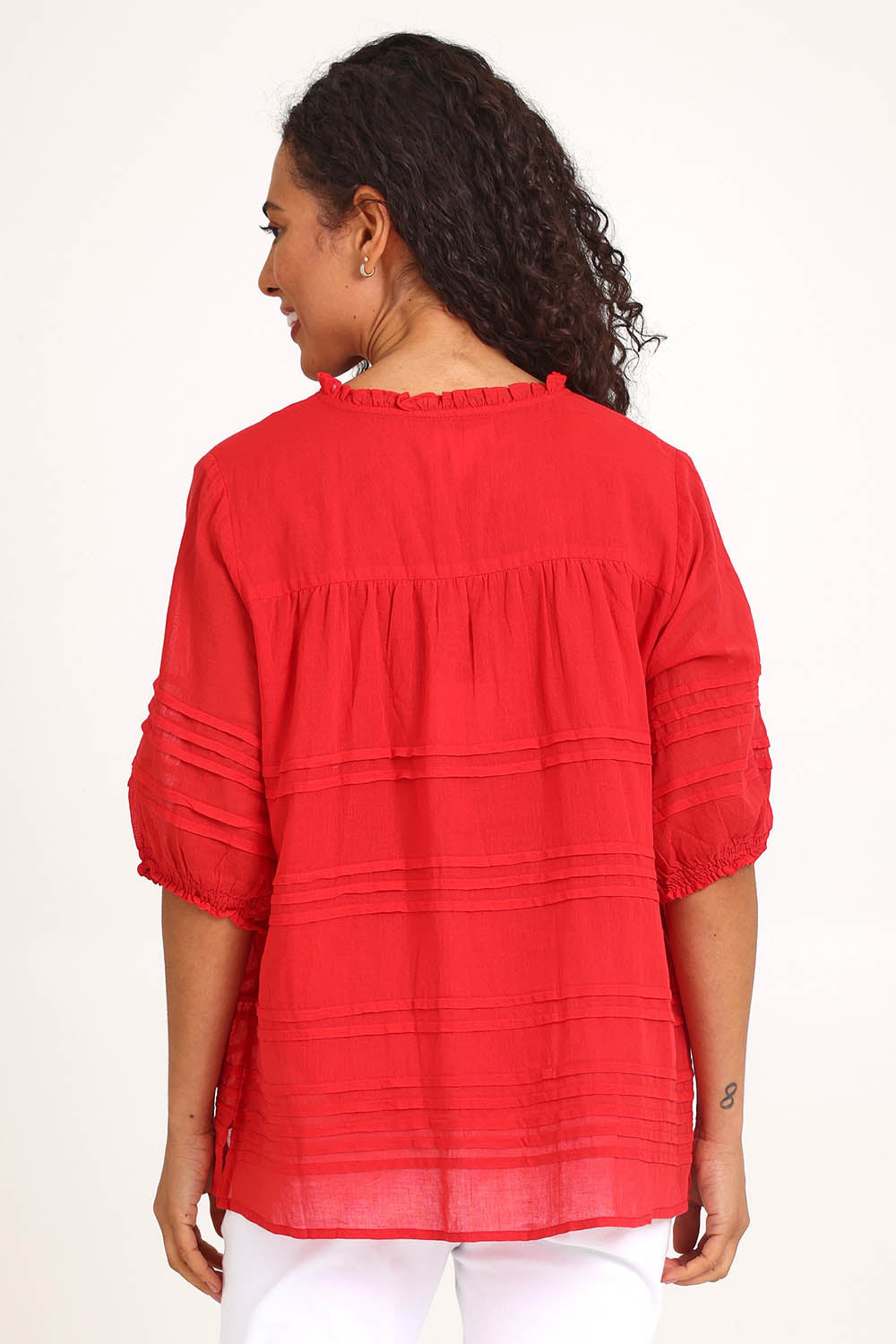 Model Pamelar wearing size 10 of the Essentials Pleated Cotton Top - Red in colour Red, from the back