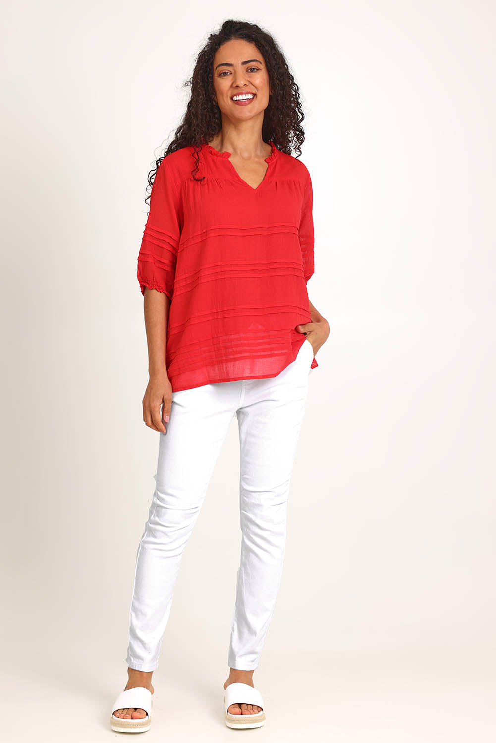 Model Pamelar wearing size 10 of the Essentials Pleated Cotton Top - Red in colour Red, from the front