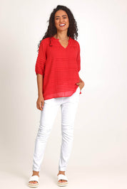 Model Pamelar wearing size 10 of the Essentials Pleated Cotton Top - Red in colour Red, from the front