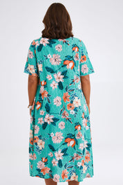 Model Monique wearing size 14 of the Kaleici V Neck Pleated Dress in colour Print (Green), from the back