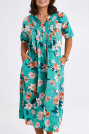 Model Monique wearing size 14 of the Kaleici V Neck Pleated Dress in colour Print (Green), from the front, cropped image
