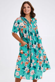 Model Monique wearing size 14 of the Kaleici V Neck Pleated Dress in colour Print (Green), from the front, cropped image