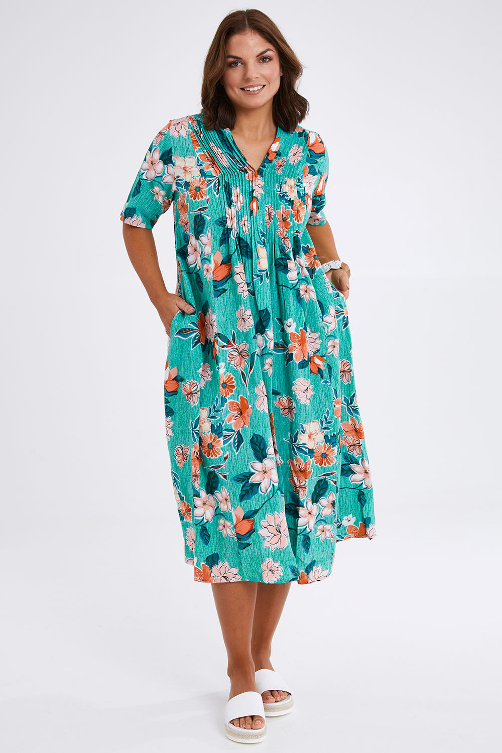 Model Monique wearing size 14 of the Kaleici V Neck Pleated Dress in colour Print (Green), from the front, showing the whole outfit