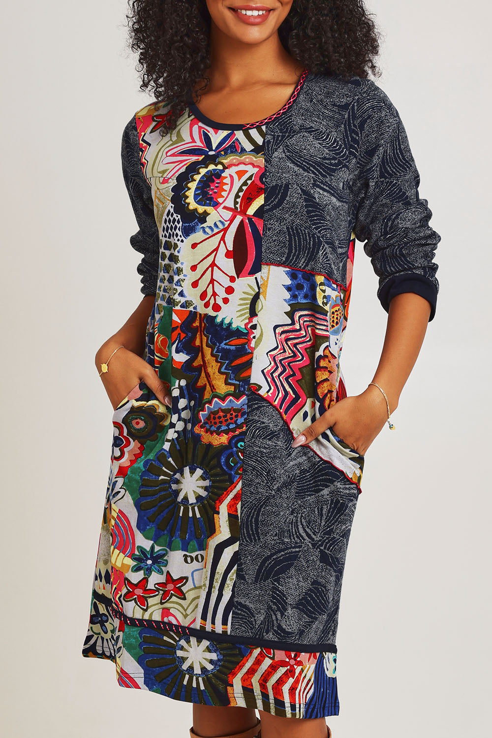 Model Ziara wearing size 10 of the Hotel California Patch Dress in colour California (Blue), from the front, cropped image