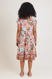 Model Ziara wearing size 10 of the Short Sleeve Layers Dress in colour Macieo, from the back