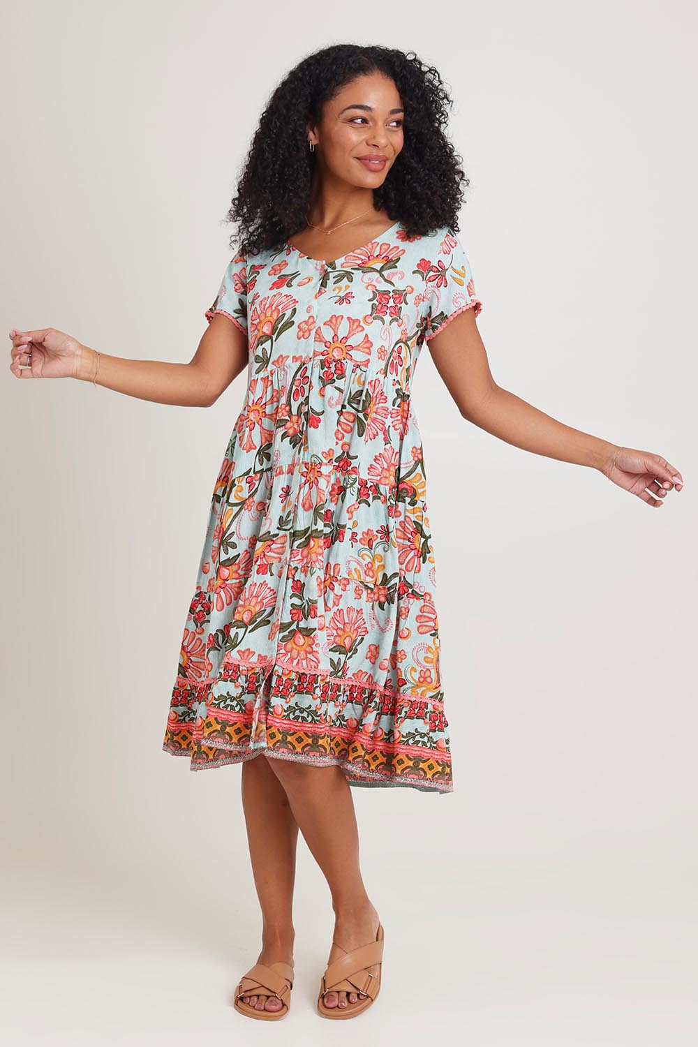 Model Ziara wearing size 10 of the Short Sleeve Layers Dress in colour Macieo, from the front, showing the whole outfit