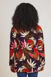 Model Ziara wearing size 10 of the Chandalier Reversible Coat in colour Chandalier (Red), from the back