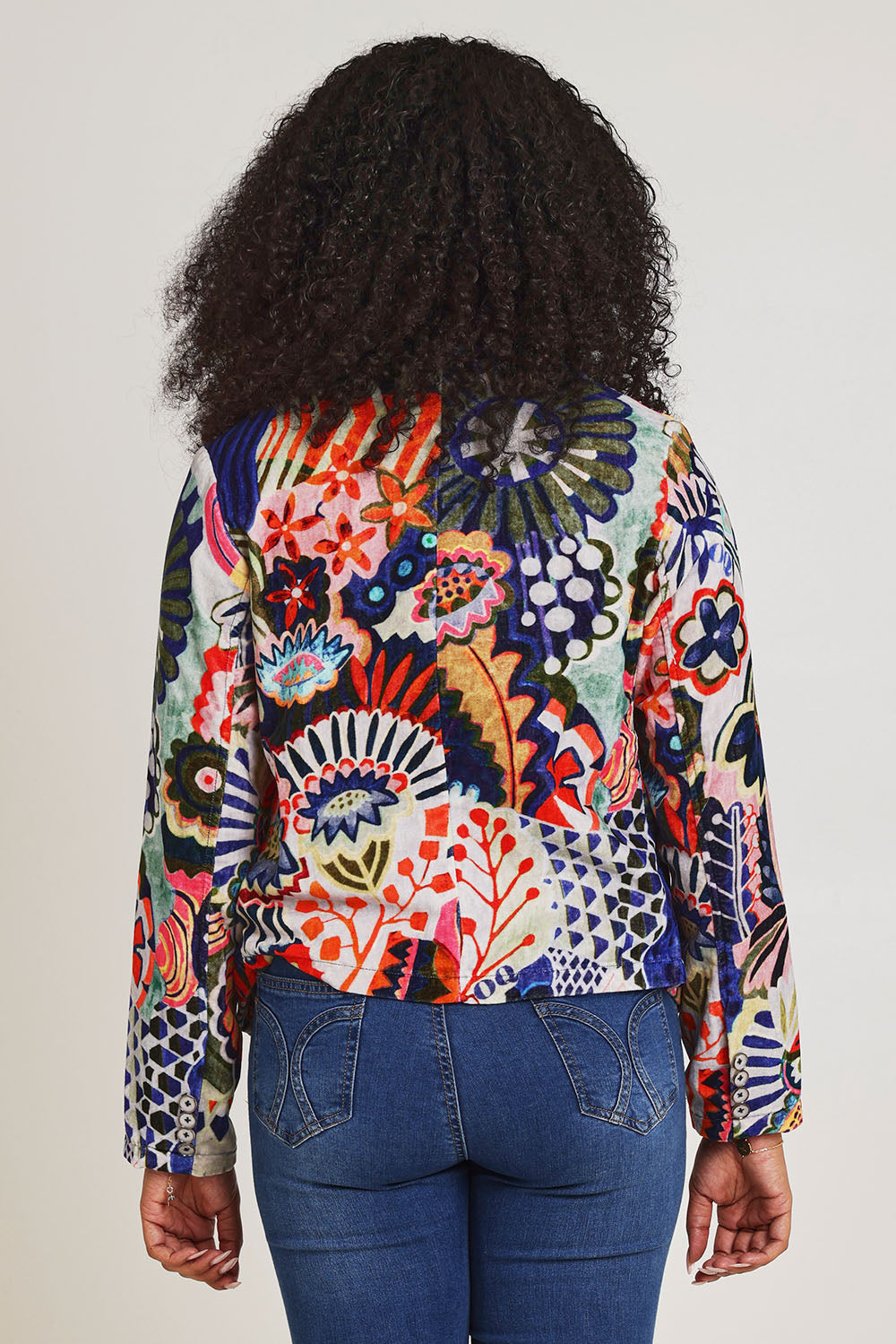 Model Ziara wearing size 10 of the Hotel California Velvet Cross Front Jacket in colour California, from the back