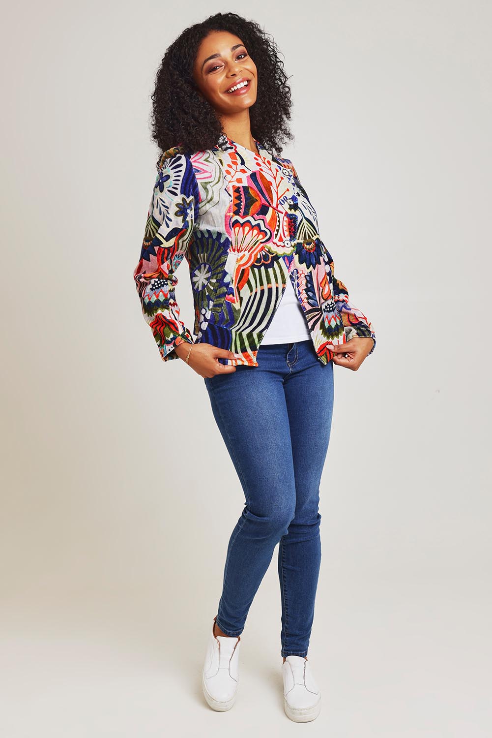 Model Ziara wearing size 10 of the Hotel California Velvet Cross Front Jacket in colour California, from the front, showing the whole outfit