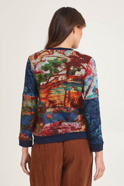 Model Madeline wearing size 10 of the Patch Cardigan in colour Nippori (Blue), from the back