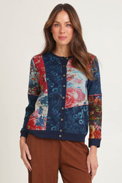 Model Madeline wearing size 10 of the Patch Cardigan in colour Nippori (Blue), from the front, cropped image