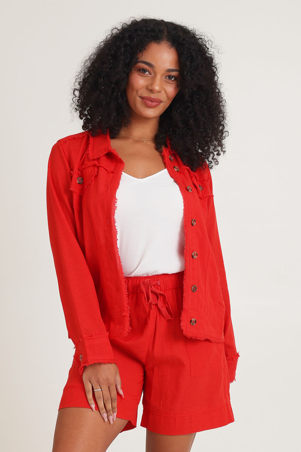 Model Ziara wearing size 10 of the Essentials Linen Blend Shorts in colour Red (Red), from the front, cropped image