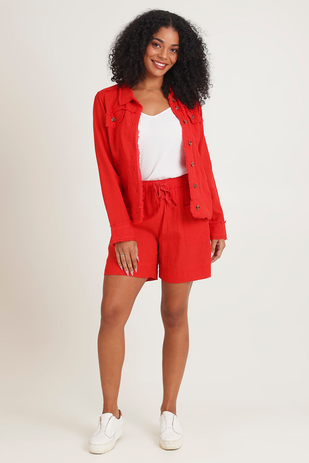 Model Ziara wearing size 10 of the Essentials Linen Blend Shorts in colour Red (Red), from the front, showing the whole outfit