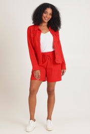 Model Ziara wearing size 10 of the Essentials Linen Blend Shorts in colour Red (Red), from the front, showing the whole outfit