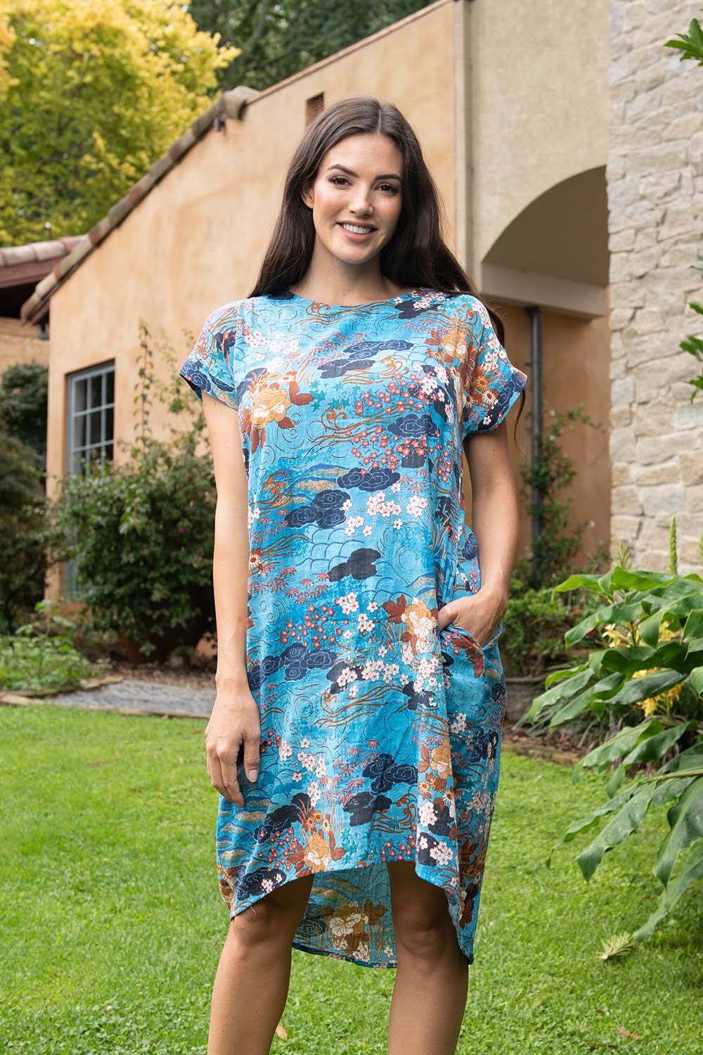 A model wearing the Parga Organic Cotton Simple Cut Dress in colour Print (Blue), from the front, showing the whole outfit
