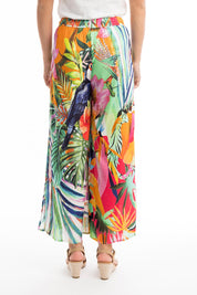 A model wearing the Rio Shirred Waist Pant in colour Rio (Green), from the back