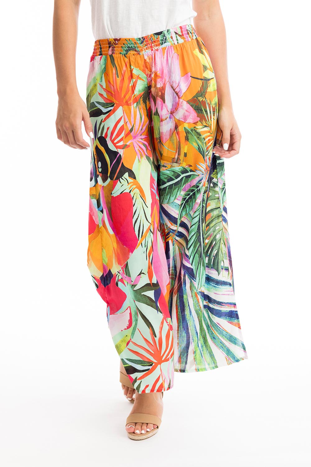 A model wearing the Rio Shirred Waist Pant in colour Rio (Green), from the front, cropped image