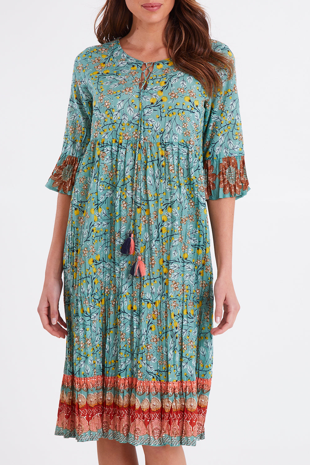 Model Madeline wearing size 10 of the Chania 3/4 Sleeve Layers Dress in colour Print (Green), from the front, cropped image