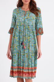 Model Madeline wearing size 10 of the Chania 3/4 Sleeve Layers Dress in colour Print (Green), from the front, cropped image